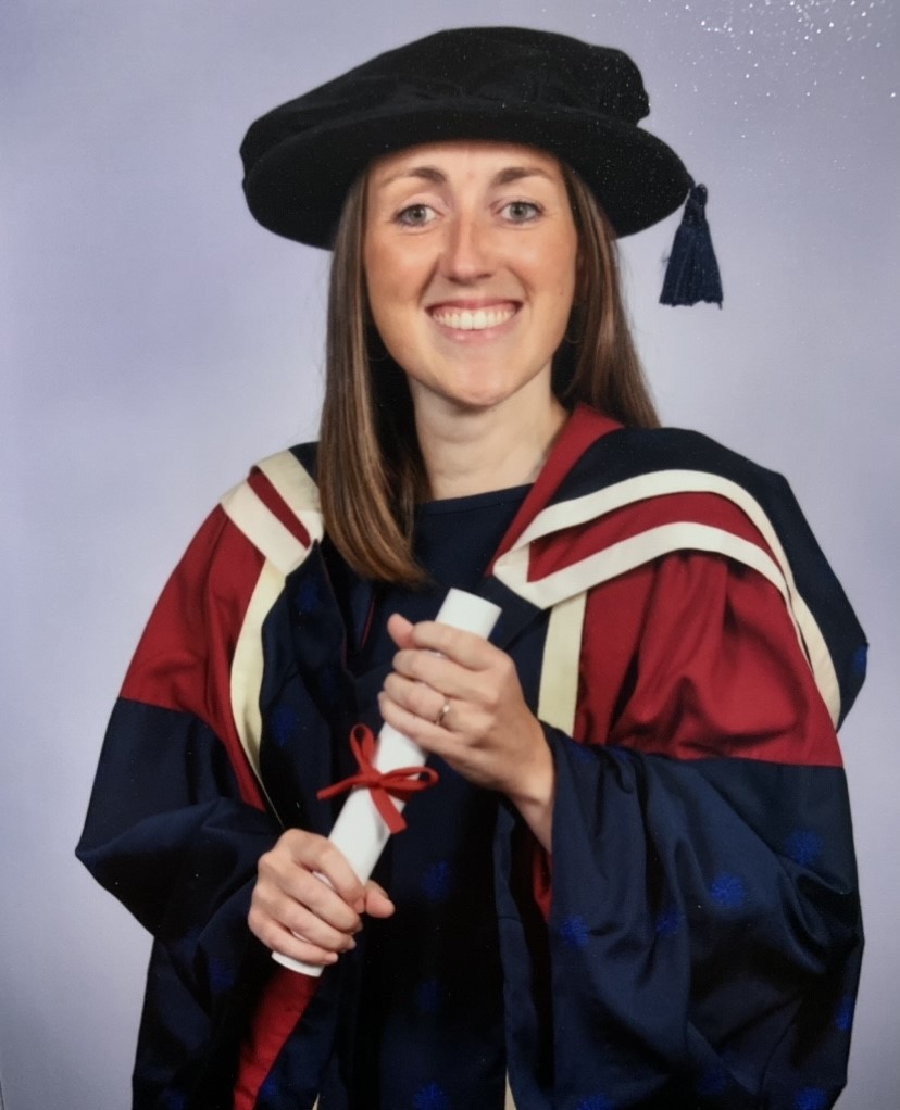 A person wearing a graduation gown and hat
