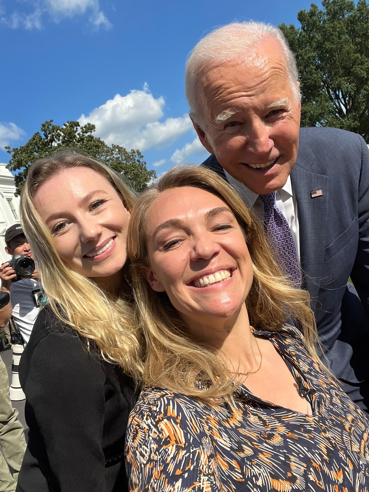 Sophie Morgan and Keely Cat Wells smiling in a selfie with President Biden.